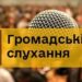 Мікрофон на тлі зали з людьми та напис «Громадські слухання» на жовтому банері.