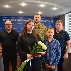 Родина загиблого військовослужбовця стоїть у залі Рівненської районної військової адміністрації під час вручення державної нагороди.